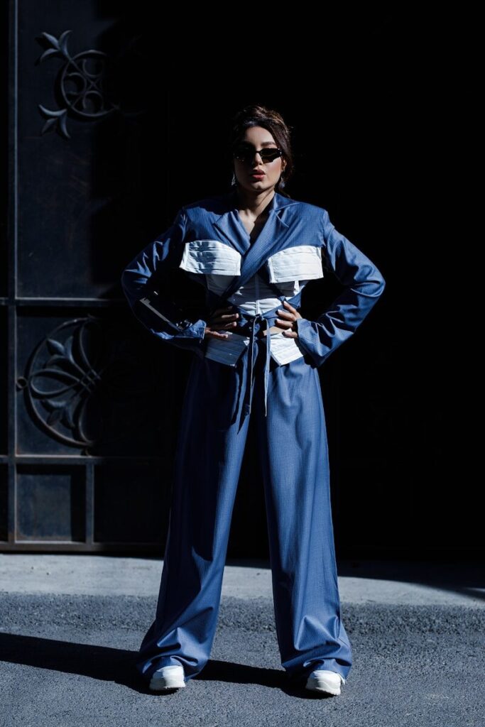 A woman standing in front of a building with her hands on her hips