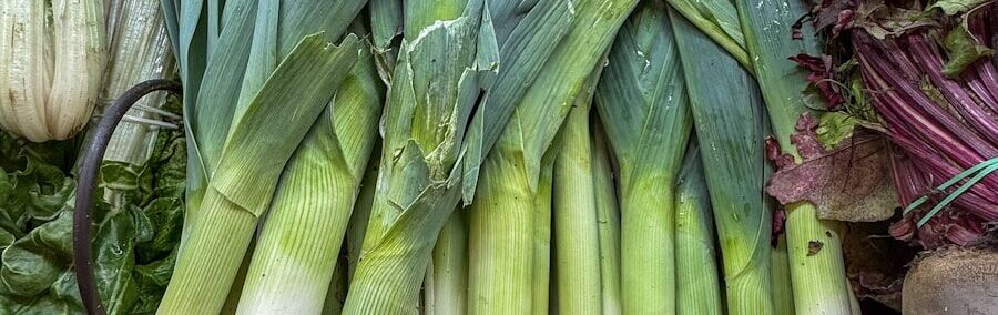 Fresh leeks are on display at a market.